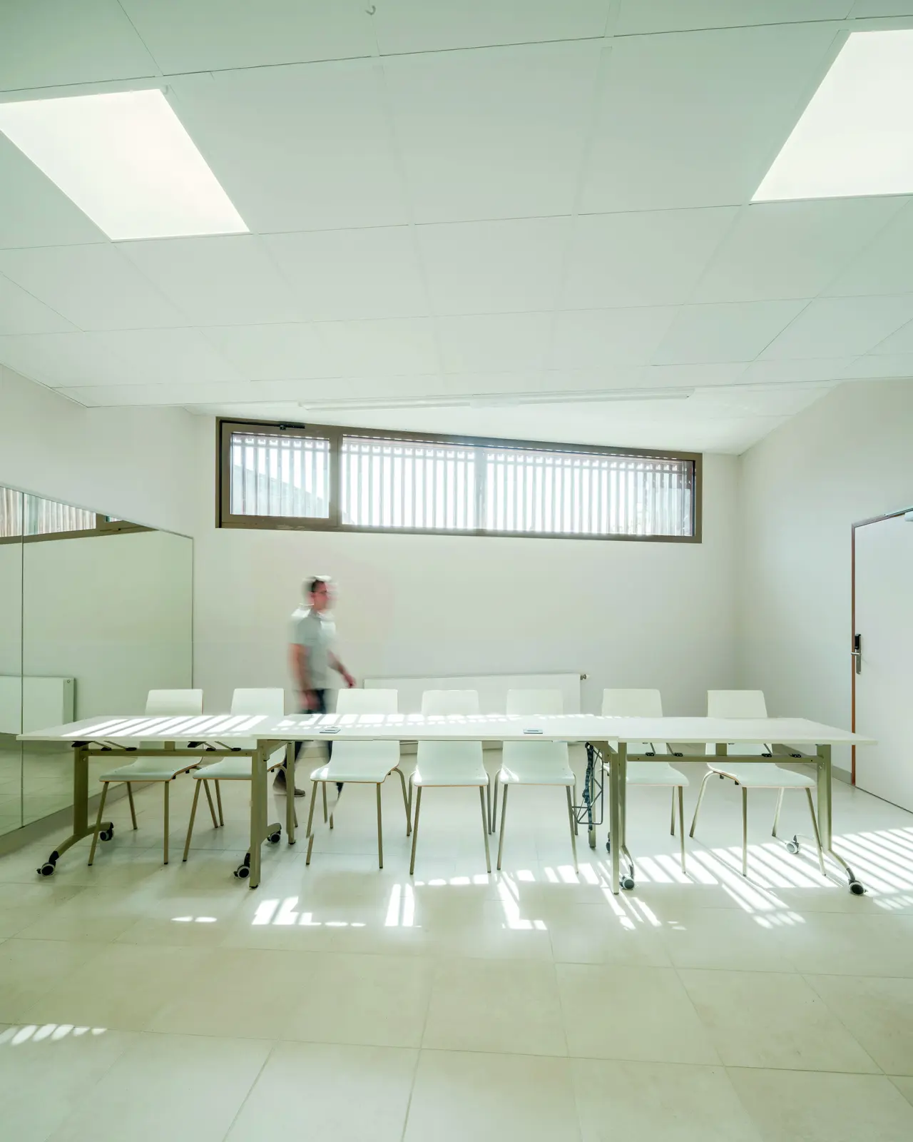Salle de r&eacute;union lumineuse sous plafond acoustique blanc